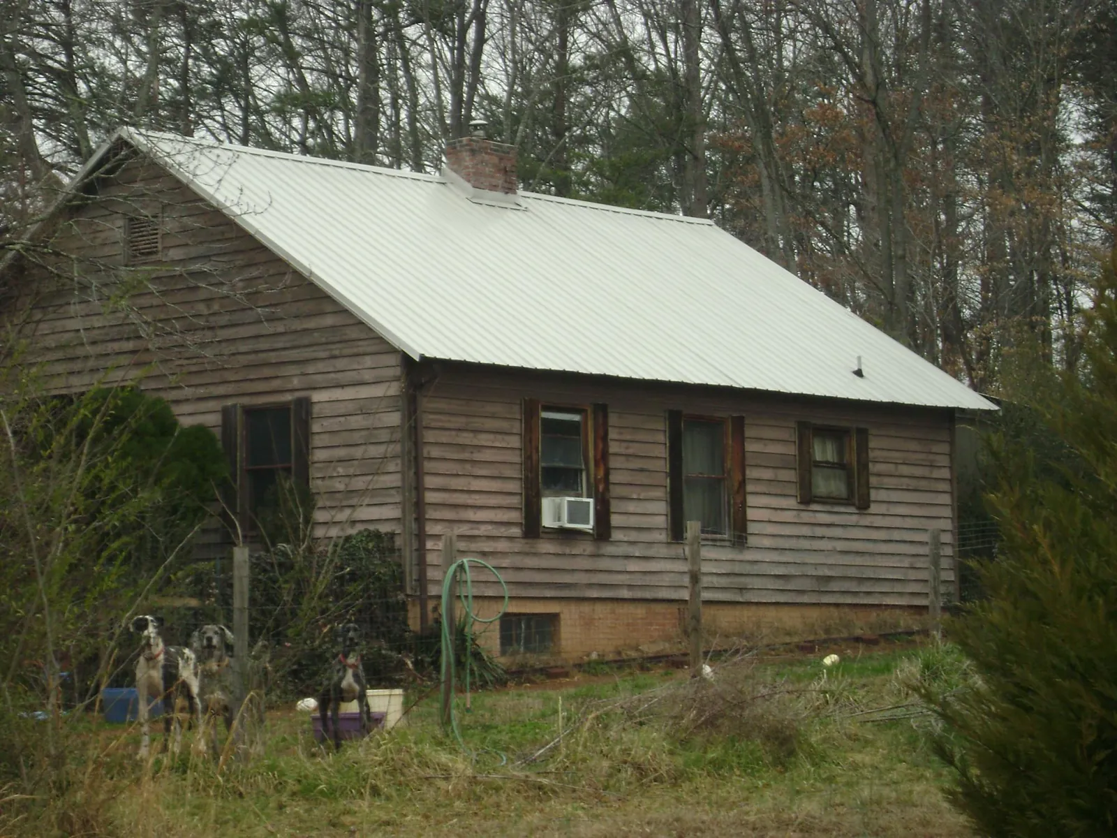White metal roof on an old wood sided farmhouse, from a Metal Roof Installation job in Gallion